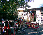 In front of the toolshed. Tools and boots are lined up ready for students to use.